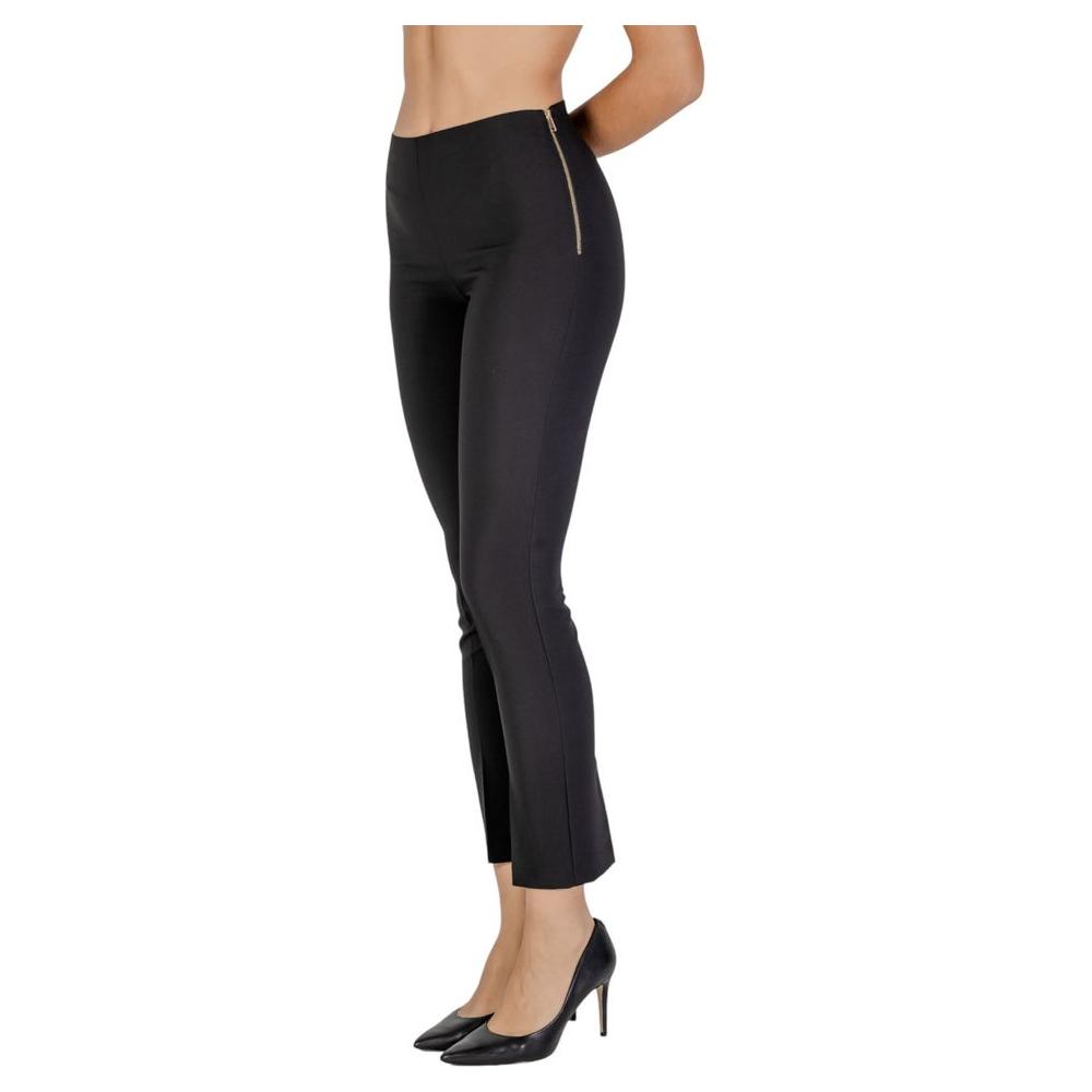 Woman wearing Sandro Ferrone black polyester jeans and pants, fall/winter collection, featuring a side zipper, elegant design.