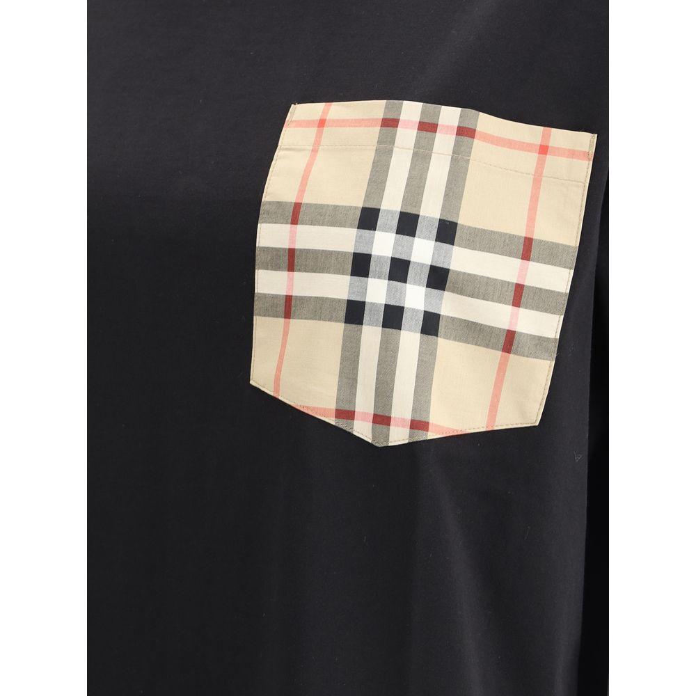 Close-up of Burberry Archive Check pocket on black T-shirt, featuring ribbed crew neck and monochrome pattern.