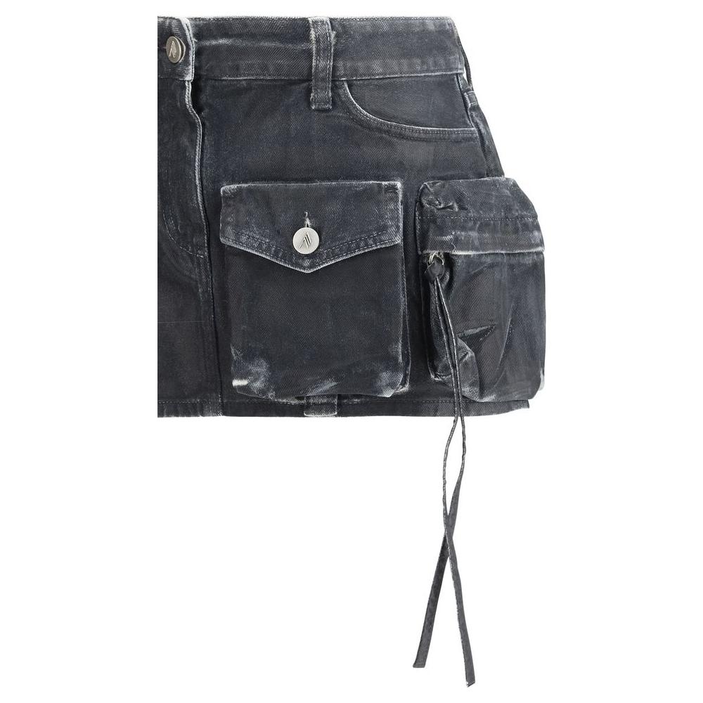 The Attico Denim Cargo Mini Skirt with front and side pockets, button closure, and leather patch detail.