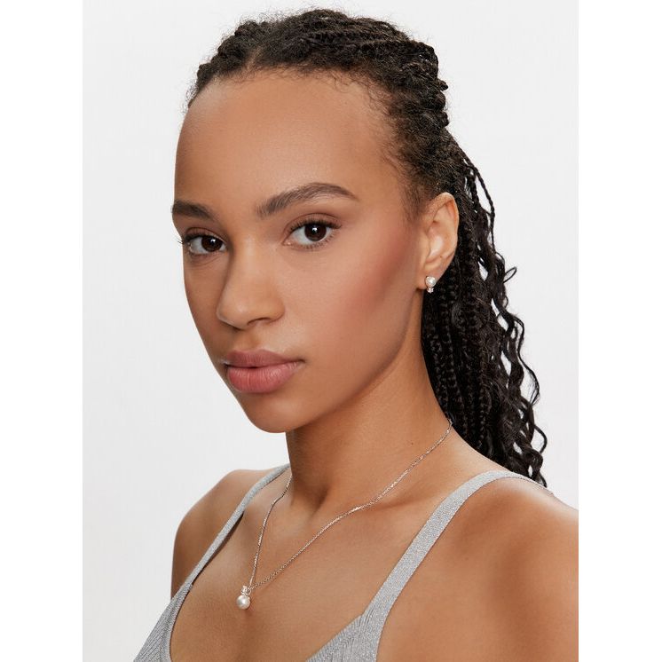 Woman wearing SWAROVSKI Mod. 5689624 earrings, shown in profile, styled with silver 925° material, perfect for elegant occasions.