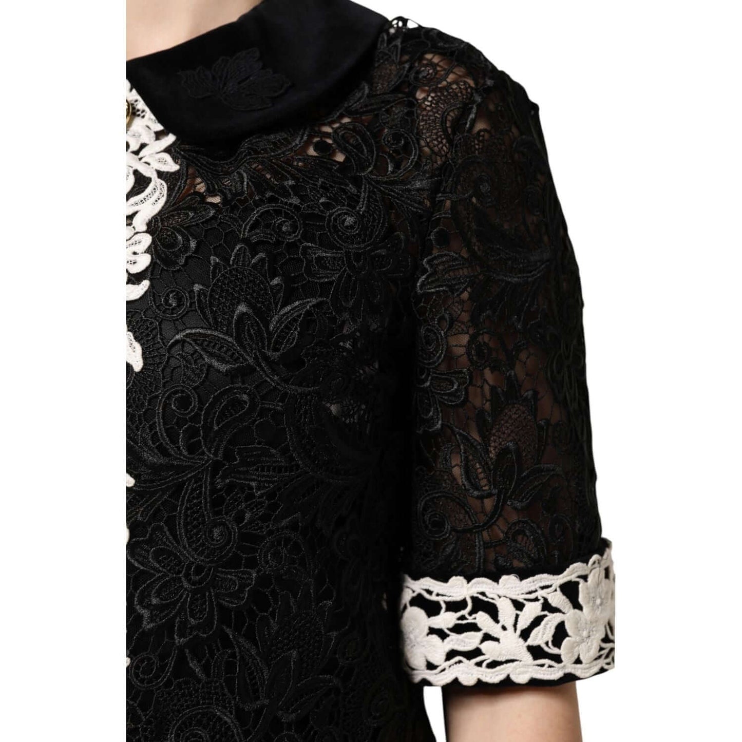 Dolce & Gabbana black floral lace mini dress with white embellishments, showcasing intricate craftsmanship and elegant design.