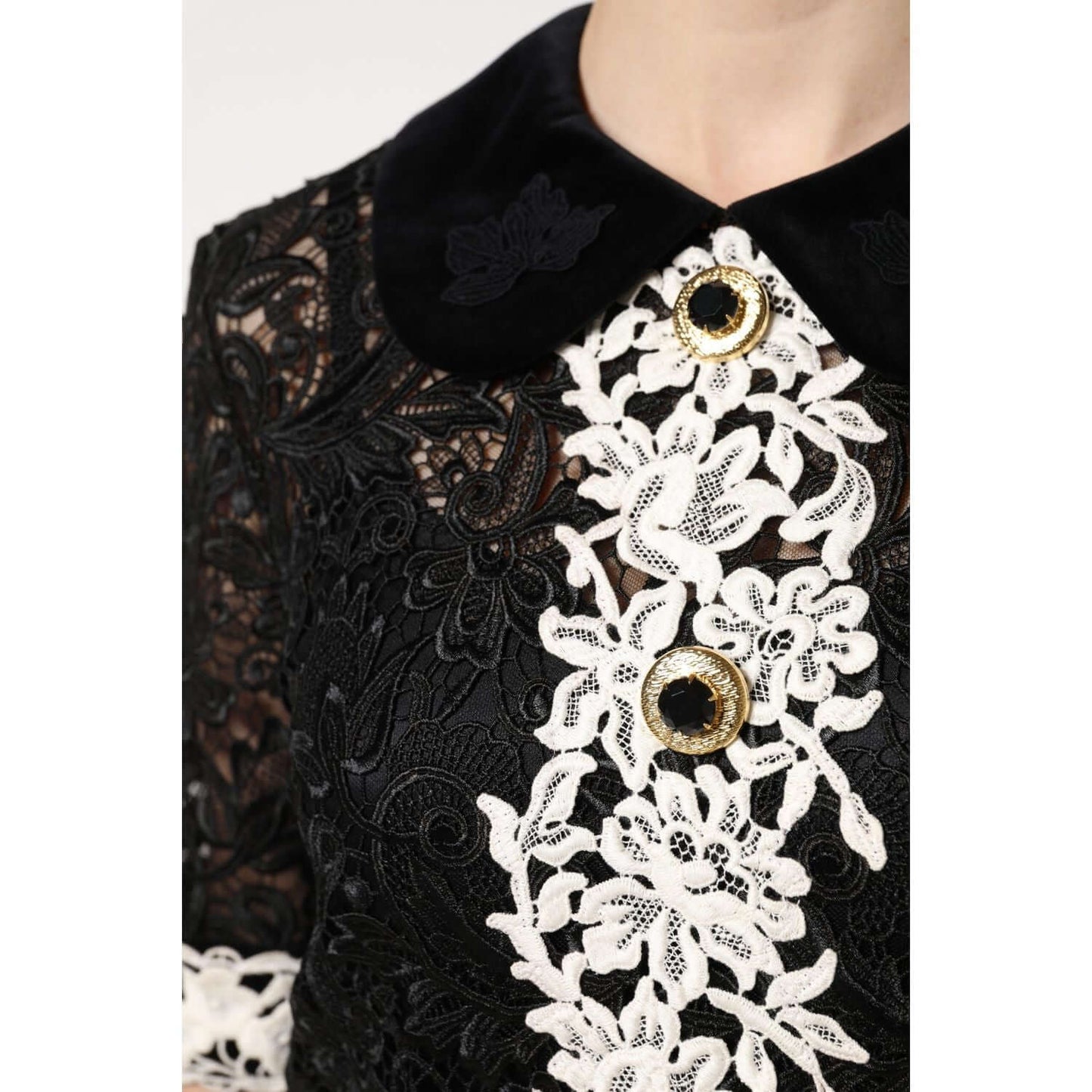 Dolce & Gabbana black floral lace embellished mini dress close-up, featuring intricate white lace and elegant button details.