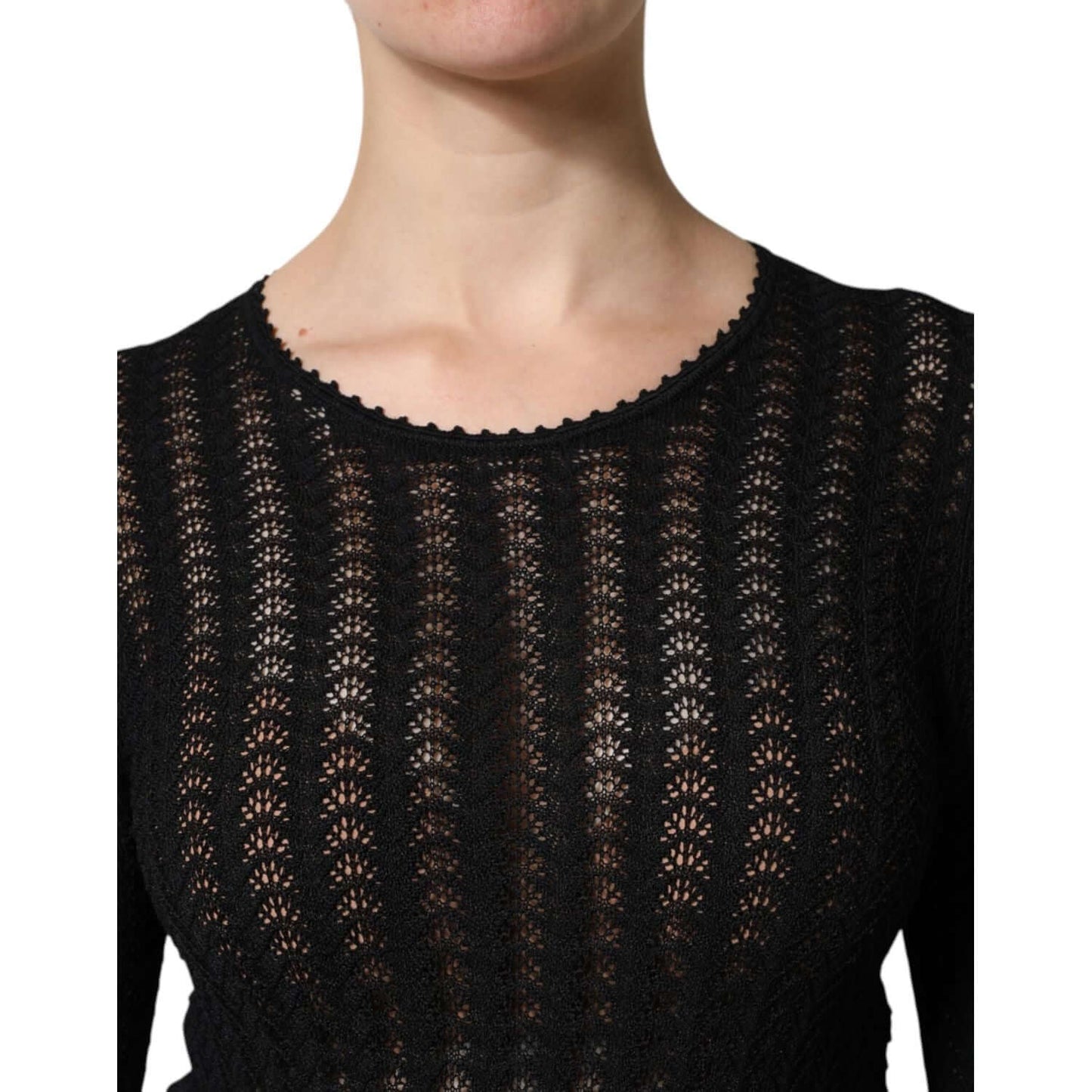 Close-up of a black lace-patterned top, showcasing intricate design and elegant craftsmanship.