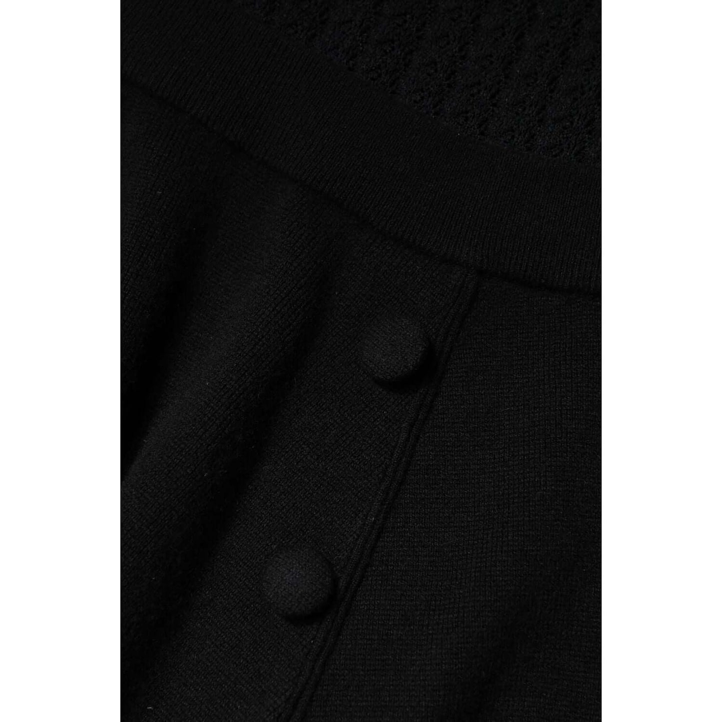 Close-up of Dolce & Gabbana black cashmere midi dress detail with buttons, showcasing high craftsmanship and luxury design.