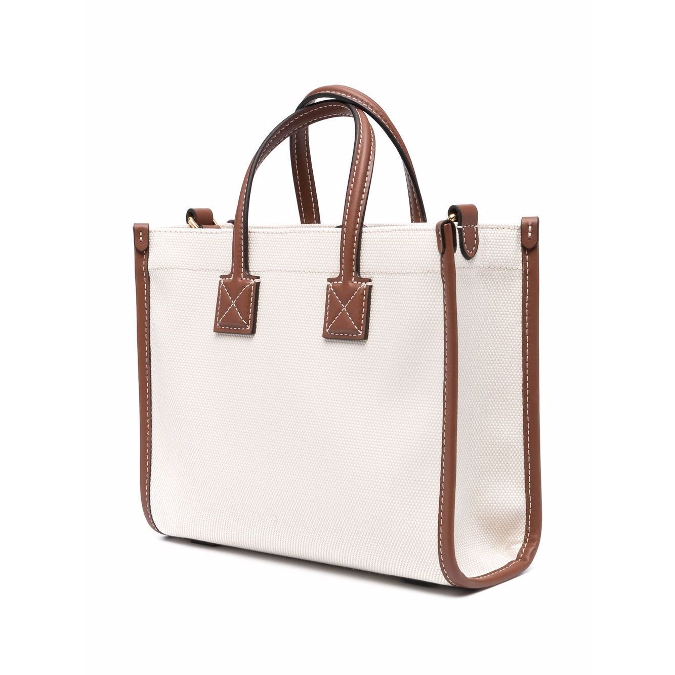 Burberry mini tote bag in cream with brown leather trim and gold-tone hardware, featuring top handles and a detachable shoulder strap.