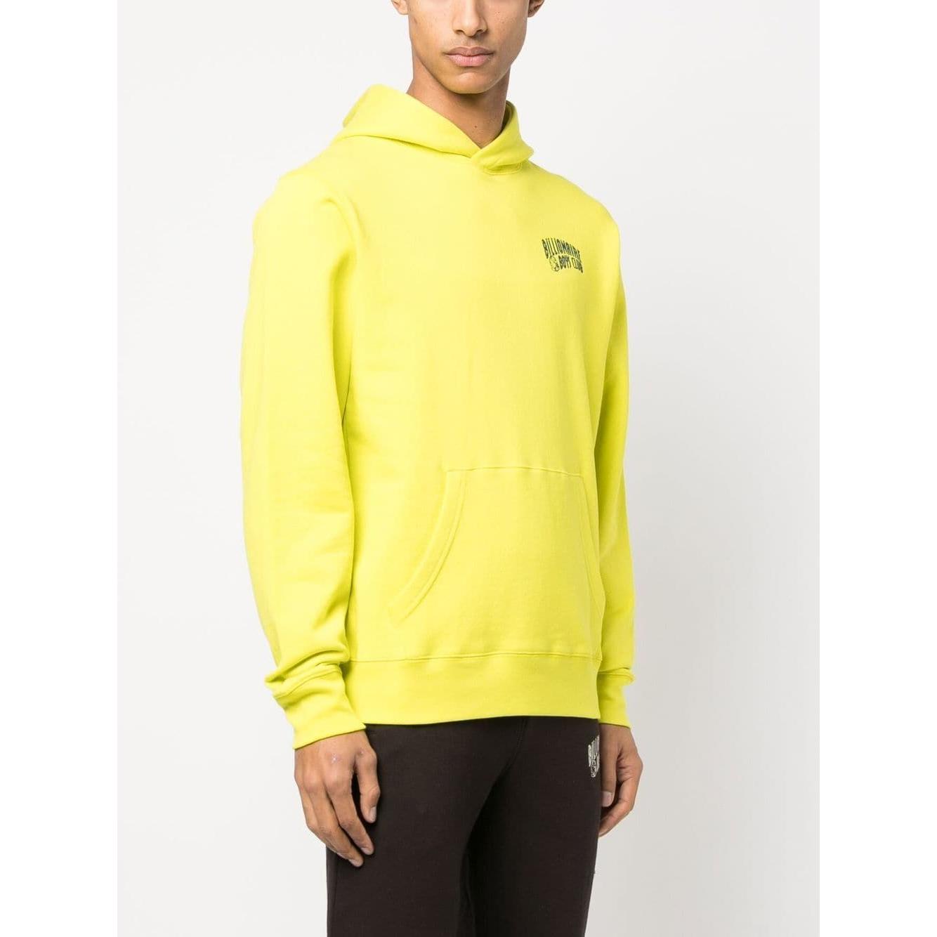 Yellow Billionaire Sweaters hoodie with chest and sleeve logo, front kangaroo pocket, and straight hem. Model is wearing size M.