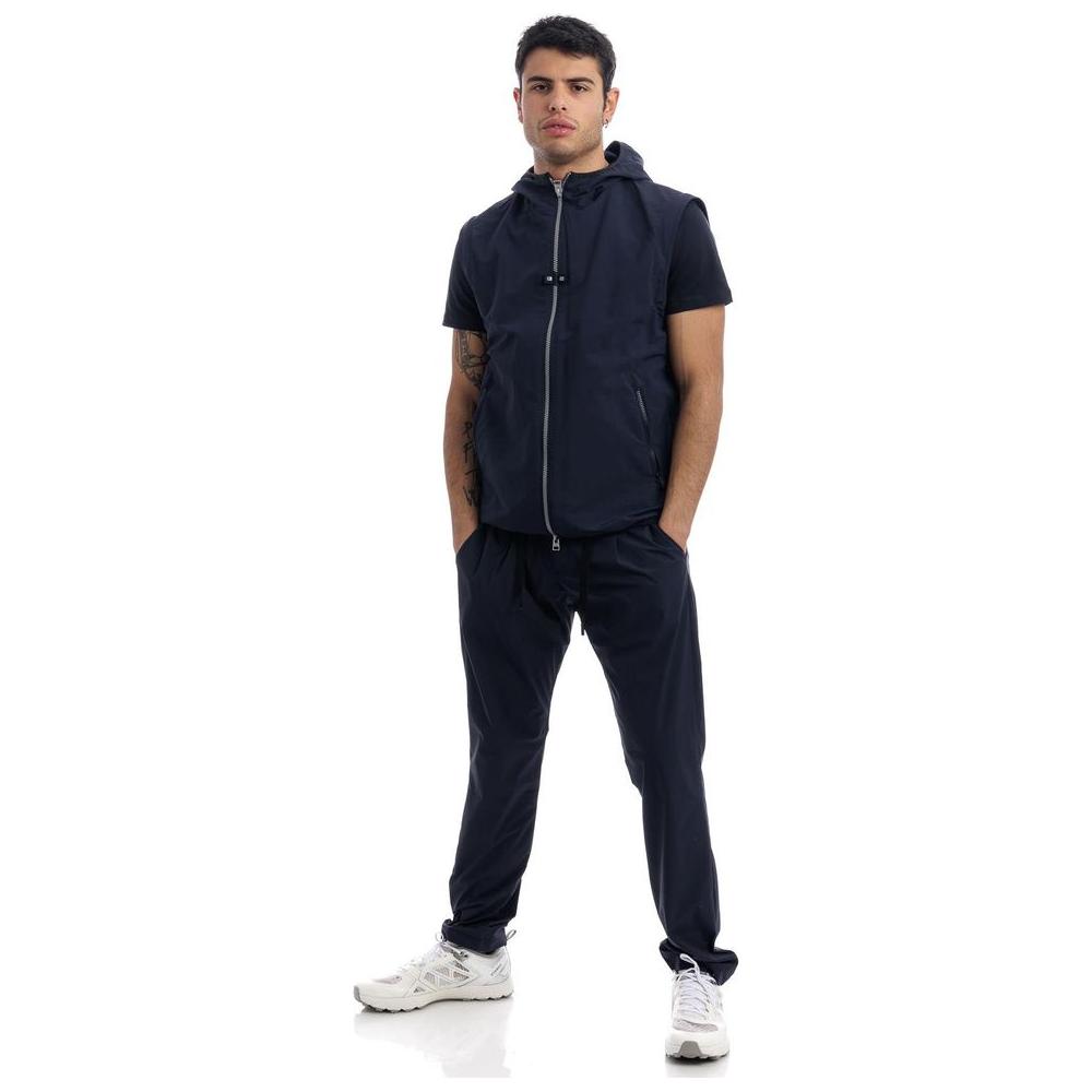 Man wearing Herno blue nylon jacket with hood and removable sleeves, featuring internal mesh lining and side pockets.