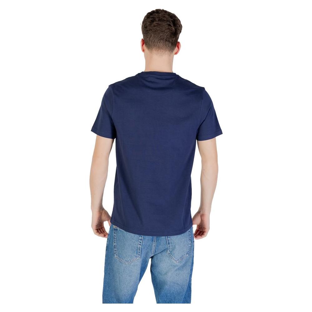 Back view of man wearing Lyle & Scott blue cotton T-shirt and jeans, showcasing casual style and comfortable fit for everyday wear.