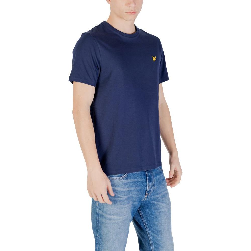 Man wearing Lyle & Scott blue cotton T-shirt with logo, paired with blue jeans, standing against white background.