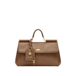 Dolce & Gabbana Sicily soft leather handbag in caramel brown with foldover top, padlock detail, single handle, and detachable strap.