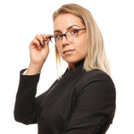 Woman wearing Bally Brown Unisex Glasses Frame in a stylish pose, highlighting the half-rim design and brown plastic material.