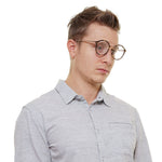 Police Brown Men Glasses Frame with metal and plastic aviator style full-rim, worn by a male model in a grey shirt.