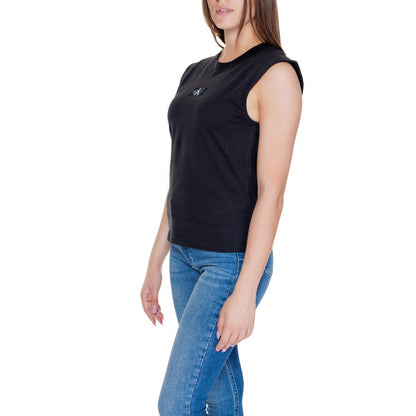 Woman wearing Calvin Klein Jeans Black Cotton T-Shirt with sleeveless design, paired with blue jeans.