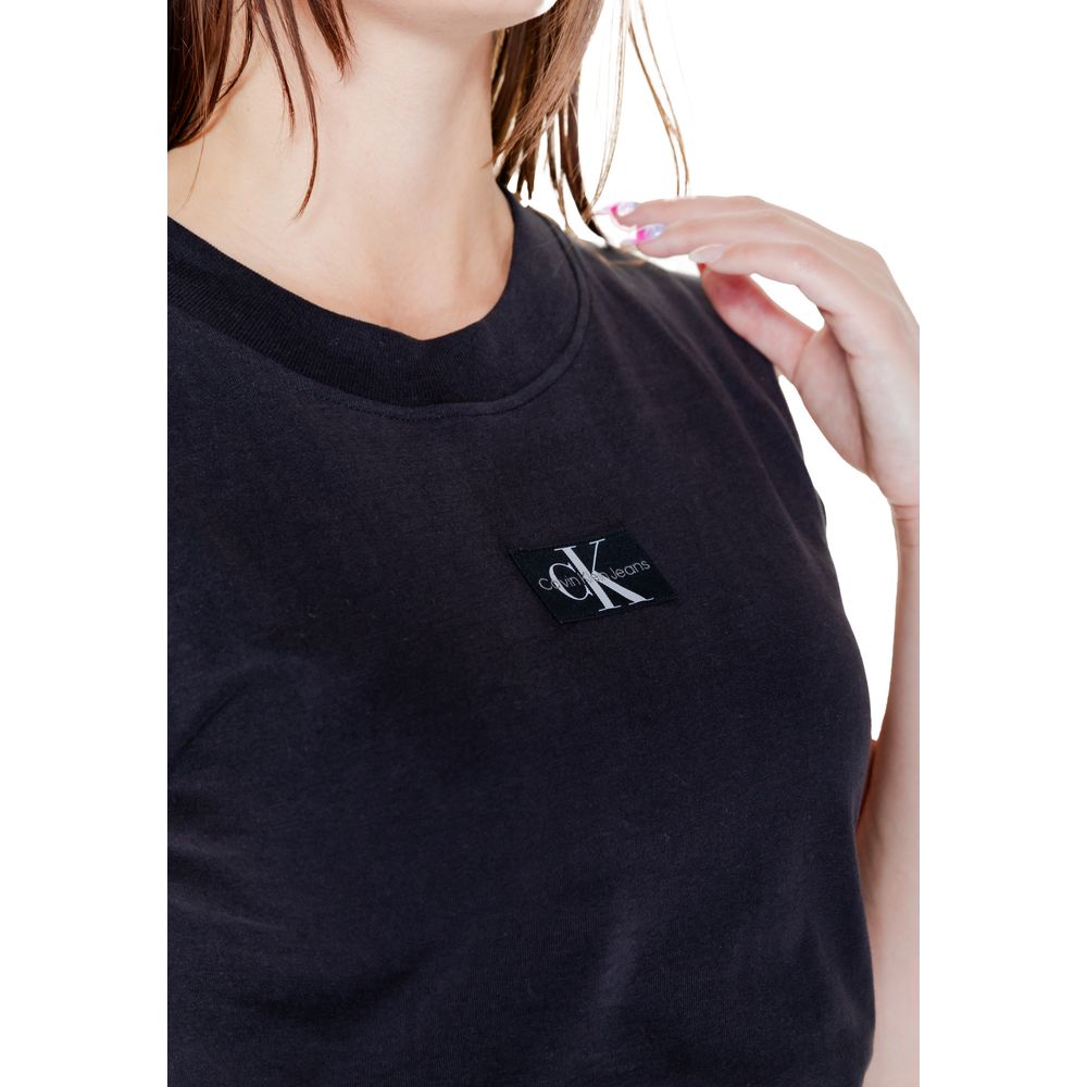 Woman wearing Calvin Klein Jeans Black Cotton T-Shirt with woven label detail, short sleeve, perfect for casual or sophisticated outfits.