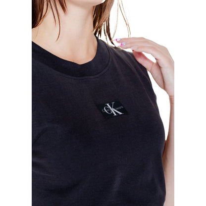 Woman wearing Calvin Klein Jeans Black Cotton T-Shirt with woven label detail, short sleeve, perfect for casual or sophisticated outfits.