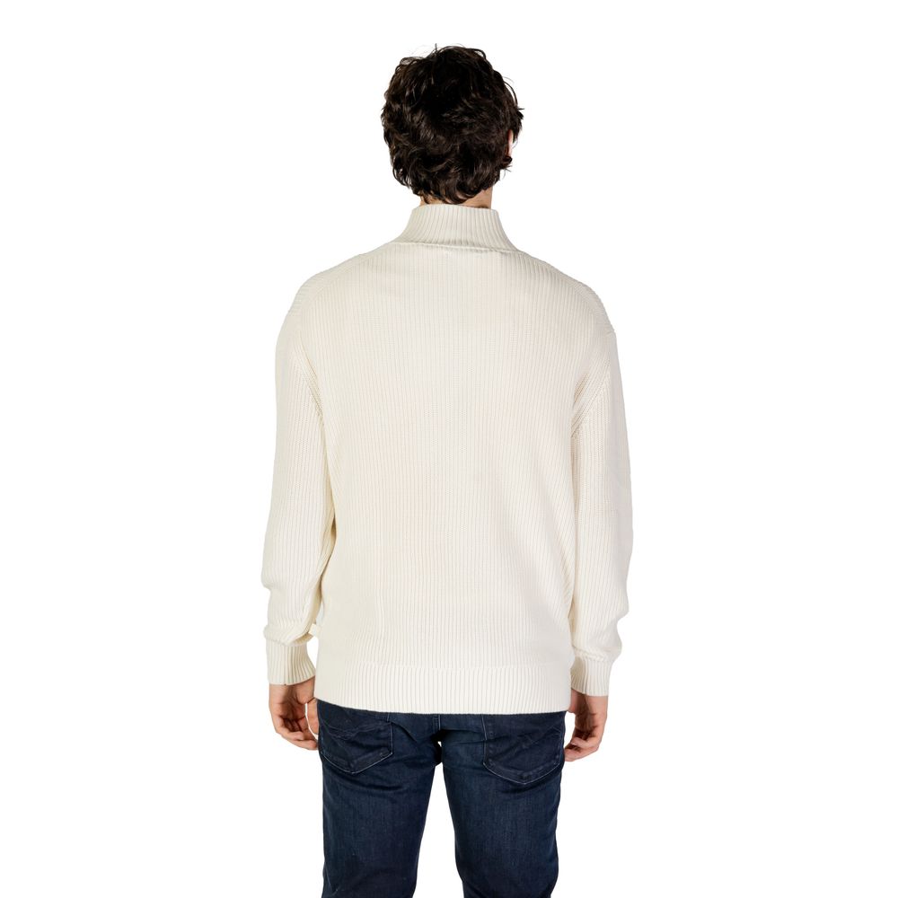 Back view of man wearing Calvin Klein Jeans Cream Cotton Sweatshirt with high neckline and mixed ribbed knit design.