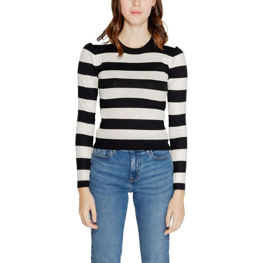 Woman wearing a black and white striped long-sleeve knit top with blue jeans, featuring Jacqueline De Yong Fall/Winter collection style.