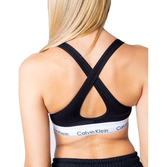 Back view of Calvin Klein Lift bralette with crossed straps and logo band in black polyester.