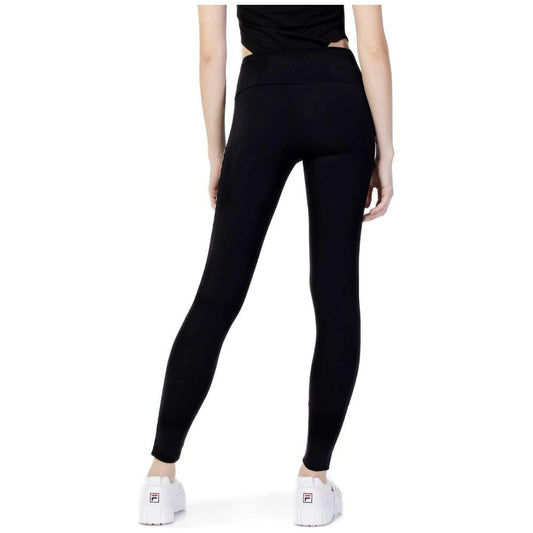 Woman wearing Guess Active black cotton leggings with high waist design, featuring logo on side, perfect for sports and active wear.