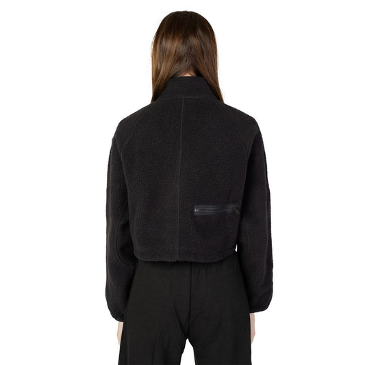 Back view of a woman wearing a Calvin Klein Sport Sherpa Black Polyester Sweater with cropped design and zip closure, ideal for cool days.