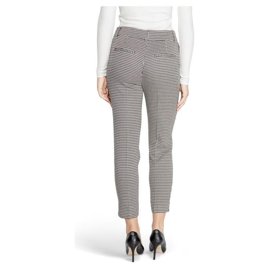 Woman wearing black and white checkered polyester pants, rear view showcasing fall winter style with high heels.