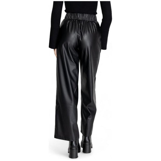 Woman wearing Jacqueline De Yong black polyester fall winter pants, back view. Ideal for women seeking stylish seasonal fashion.