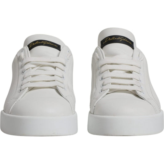 Front view of Dolce & Gabbana white leather low top sneakers with logo detail and rubber sole, slightly preowned.