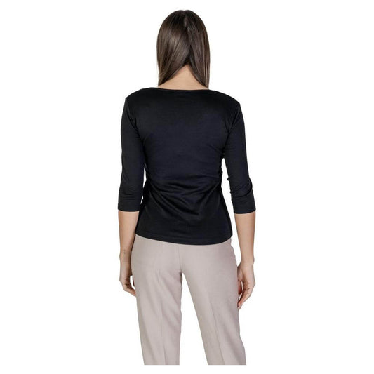 Woman wearing Street One black cotton short-sleeved t-shirt, back view, part of spring/summer collection, with beige pants.