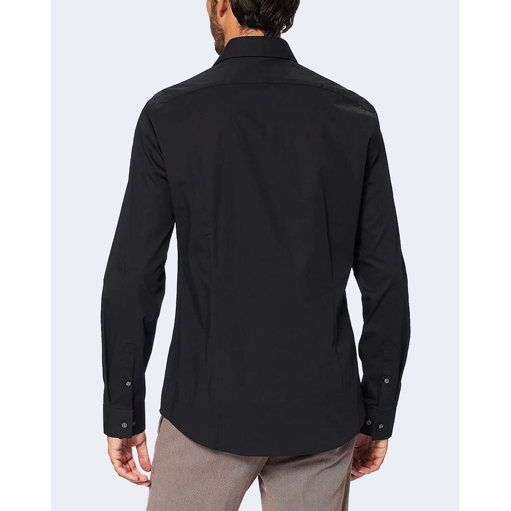 Back view of Calvin Klein Black Cotton Dress Shirt, long-sleeve, stretch poplin, slim fit, ideal for formal wear, model wearing gray pants.