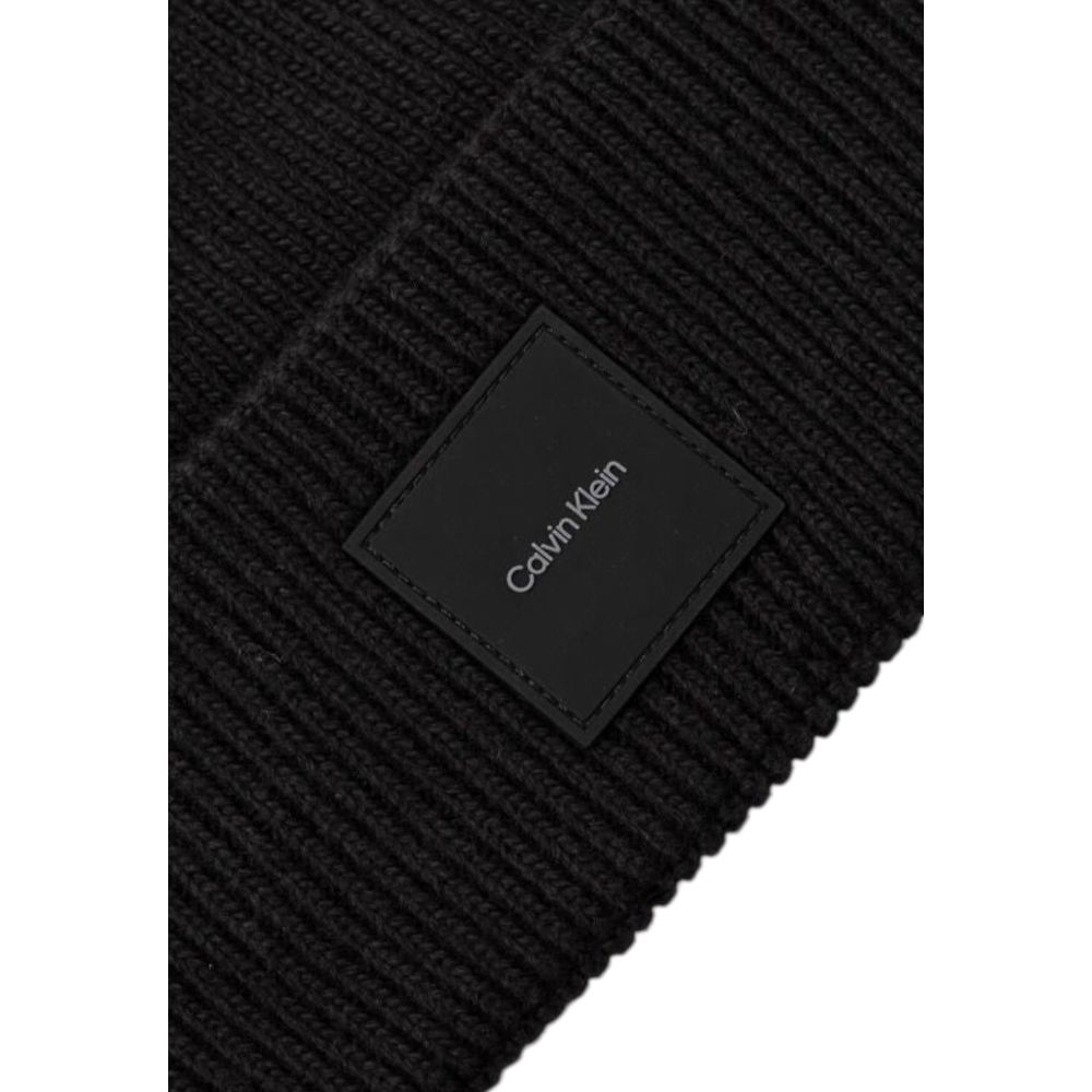Close-up of Calvin Klein Black Organic Cotton Cap (Baseball Hat) label on ribbed fabric for winter style and warmth.
