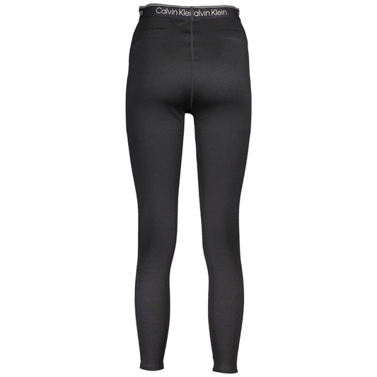 Back view of Calvin Klein black polyester women's leggings with elastic waistband and logo detail, showcasing urban chic style.