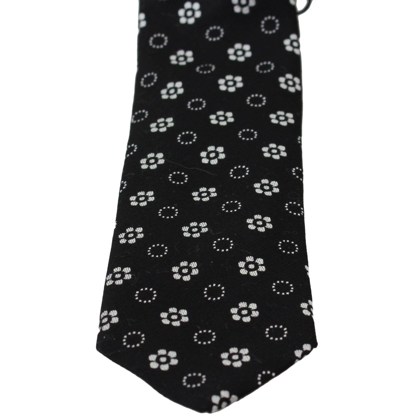Dolce & Gabbana silk floral tie with black background and white floral pattern.