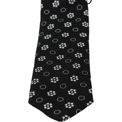 Dolce & Gabbana silk floral tie with black background and white floral pattern.