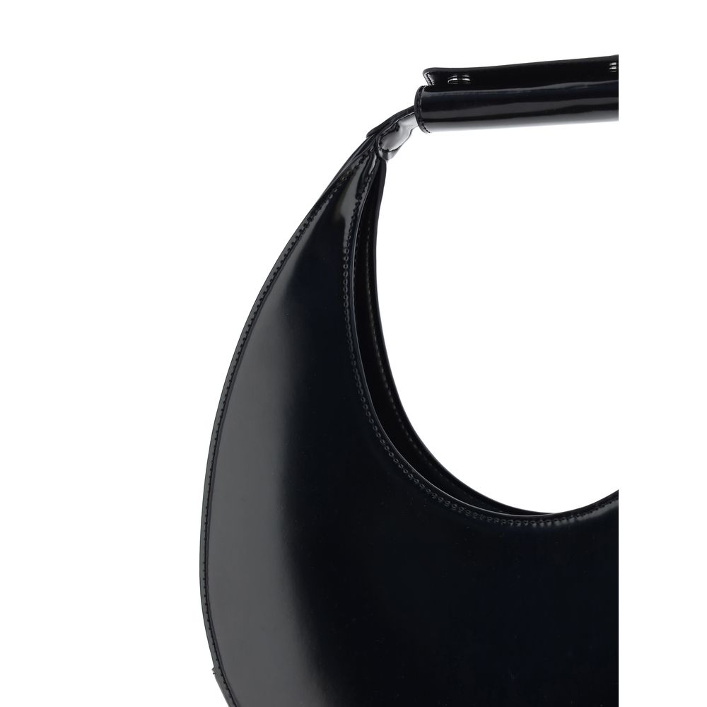 Close-up of Staud Black Calf Leather Bos Taurus Shoulder Bag showcasing iconic round moon shape and rigid handle.