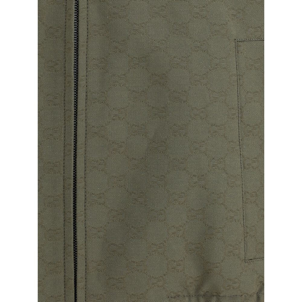 Close-up of Gucci Green Cotton Bomber fabric texture with zipper detail, showcasing the iconic GG Supreme pattern.