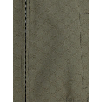 Close-up of Gucci Green Cotton Bomber fabric texture with zipper detail, showcasing the iconic GG Supreme pattern.