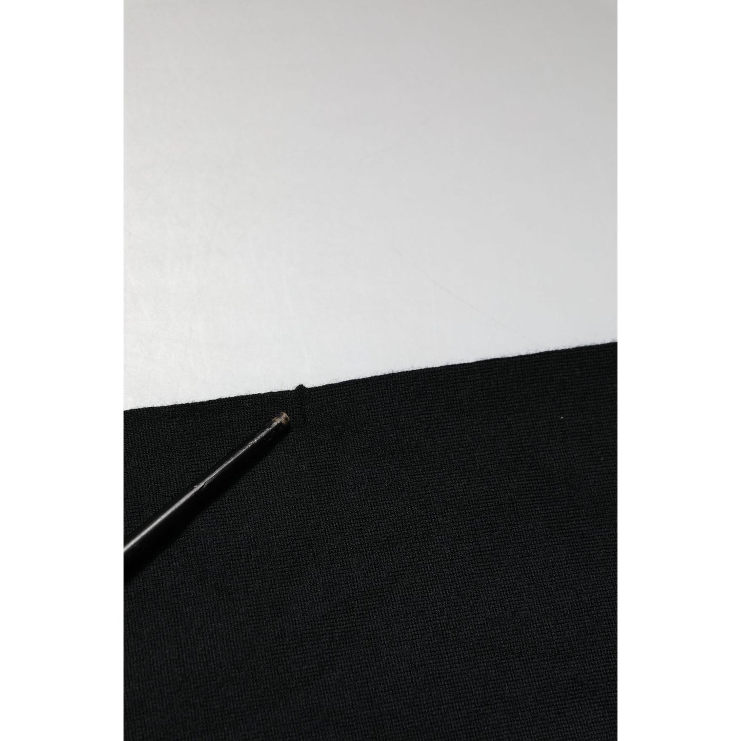 Detail of Dolce & Gabbana Black Cashmere Polo Men Longsleeves Sweater fabric texture with fine stitch work and black surface.
