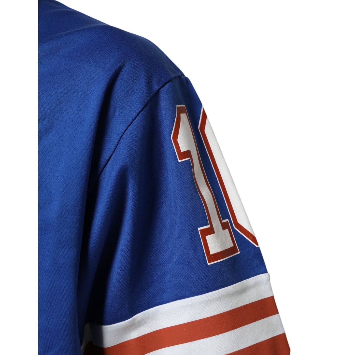 Close-up of Dolce & Gabbana Blue Cotton DG Logo Mesh Jersey T-shirt with number detail on sleeve, blue with white and red accents.