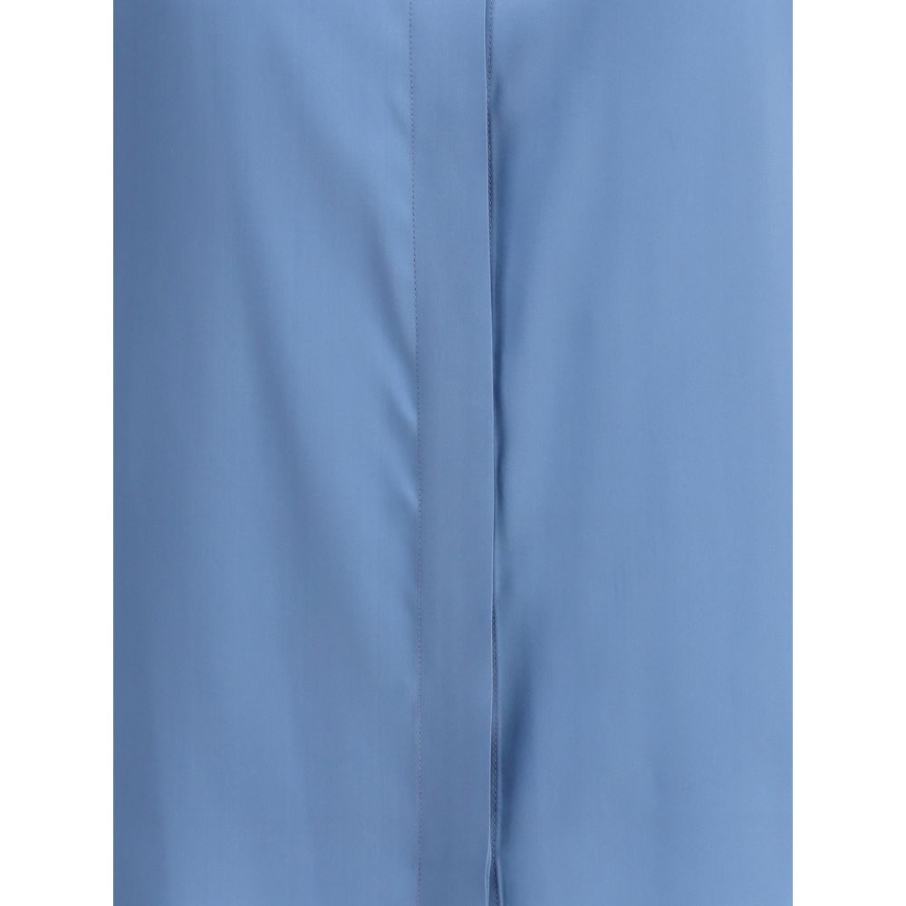 Close-up of Crida Milano Light Blue Silk Shirt showcasing smooth luminous satin texture and minimalist design.