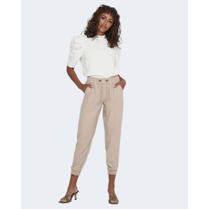 Woman modeling Only Beige Viscose Casual Pants with elastic cuffs and pull-up design, paired with a white top for a stylish look.