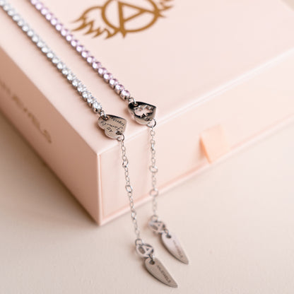 AN JEWELS JEWELRY Mod. AL.BLIYMPK silver and pink necklaces on a light pink jewelry box.