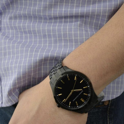 A|X ARMANI EXCHANGE Mod. HAMPTON wristwatch, stainless steel strap, 45 mm case, worn on a man's wrist with blue striped shirt.