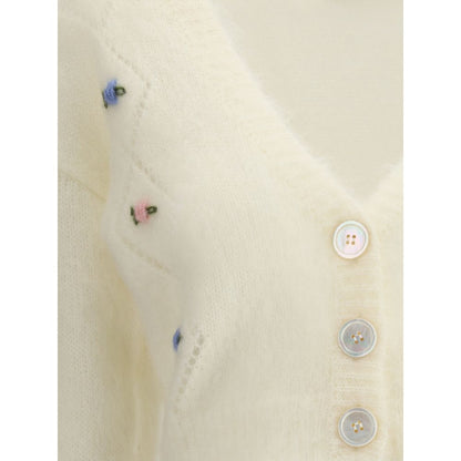 Close-up of Alessandra Rich White Mohair Cardigan with floral embroidery, button closure, and ribbed hem in a retro-inspired design.