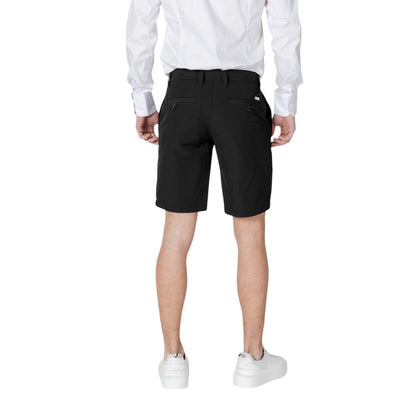 Back view of Armani Exchange Black Polyamide Bermuda Shorts worn by model, featuring welt pockets.