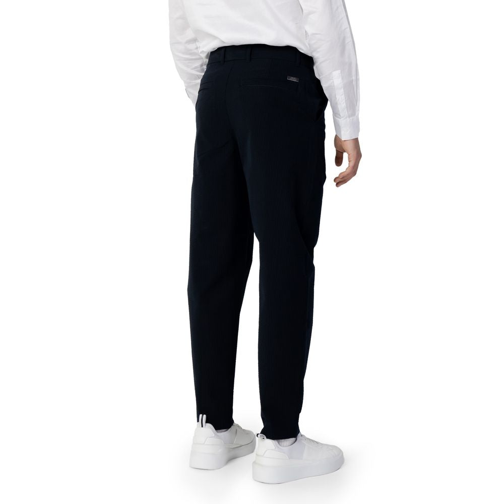 Back view of Armani Exchange Blue Cotton Casual Pants on male model in white sneakers and shirt