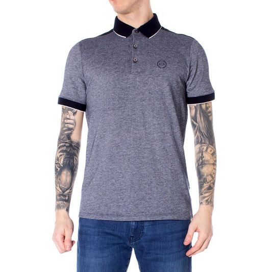 Model wearing Armani Exchange Blue Cotton Polo Shirt with tattoos, showcasing short sleeves and modern design.