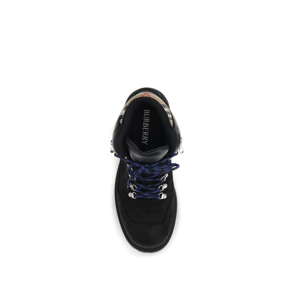 Top view of Burberry Black Calf Leather Bos Taurus Lace-Up Boots with blue-striped laces and Burberry branding on the interior.