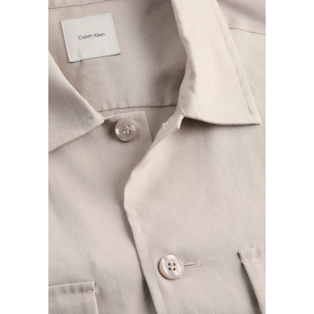 Close-up of Calvin Klein Beige Lyocell Jackets And Coat with buttons and collar detail on elegant men's long-sleeve shirt.
