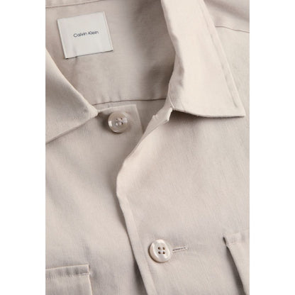 Close-up of Calvin Klein Beige Lyocell Jackets And Coat with buttons and collar detail on elegant men's long-sleeve shirt.