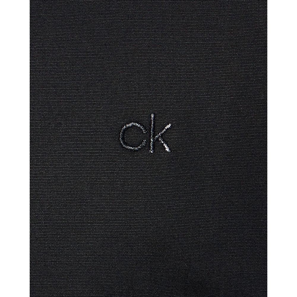 Close-up of Calvin Klein Black Cotton Dress Shirt fabric with 'ck' logo embroidered.